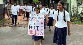 School kids march through streets, sloganeering against drug abuse