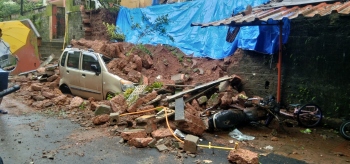 2 vehicles damaged as wall collapses in Curti