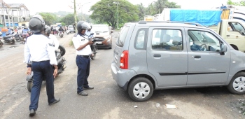 Traffic cell cracks whip on trucks parked alongside wholesale fish market road