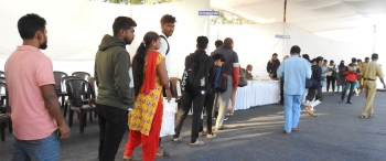 Commuters wait outside KTC bus stand to catch buses to destination