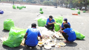 Agency workers clear loads of trash left behind by rally participants