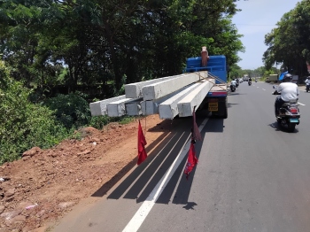 Vehicle booked for transporting power poles in violation at Sirlim