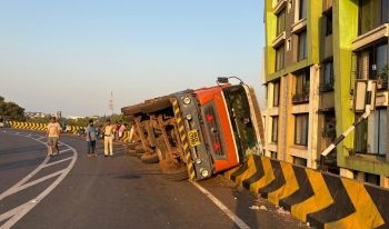 Loaded truck falls on its side on port connectivity flyover
