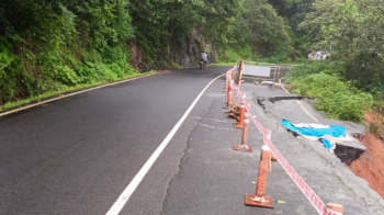Repair work underway at Anmod Ghat after road caves in; single-lane traffic in place