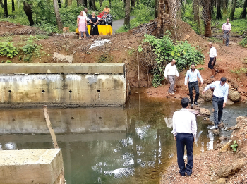 Hollant locals hop across stream as bridge work is incomplete