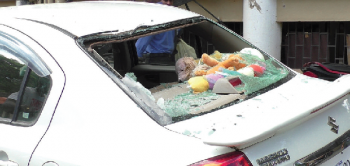 Car damaged after rusted electric pole falls on it