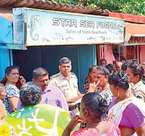Fisherwomen clash with wholesaler selling fish behind closed shop in port town