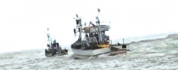 Fishing boats venture out with care from river Sal