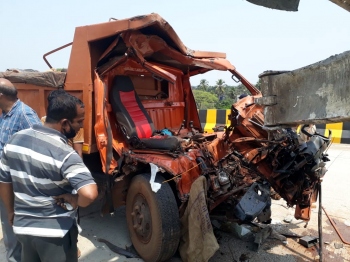 Trapped in mangled cabin, firemen rescue truck driver