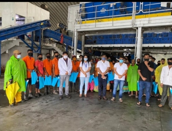 Bank distributes masks, umbrellas to waste management workers