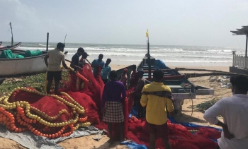 Turbulent waters keep traditional fishermen anchored