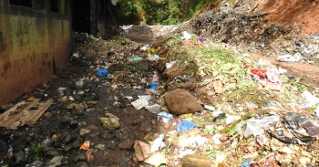 With the Sonsodo plant choked, municipality workers unload waste on approach road