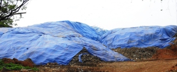 As monsoons loom, annual ritual of covering dumps begins