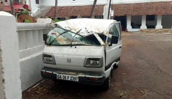 Lucky escape for elderly couple as coconut tree falls on car at Velsao